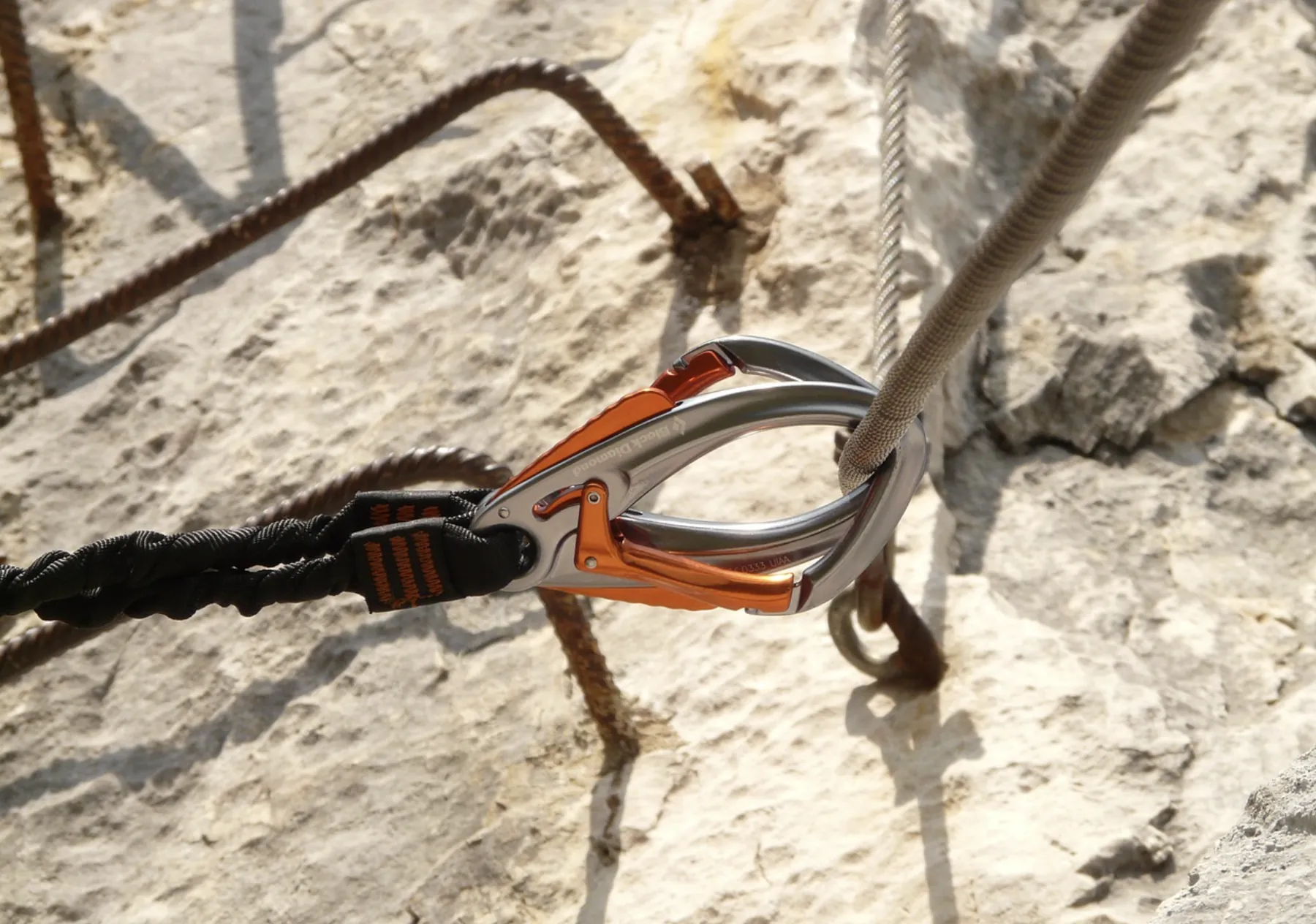 A carabiner anchored in the rock, on a via ferrata